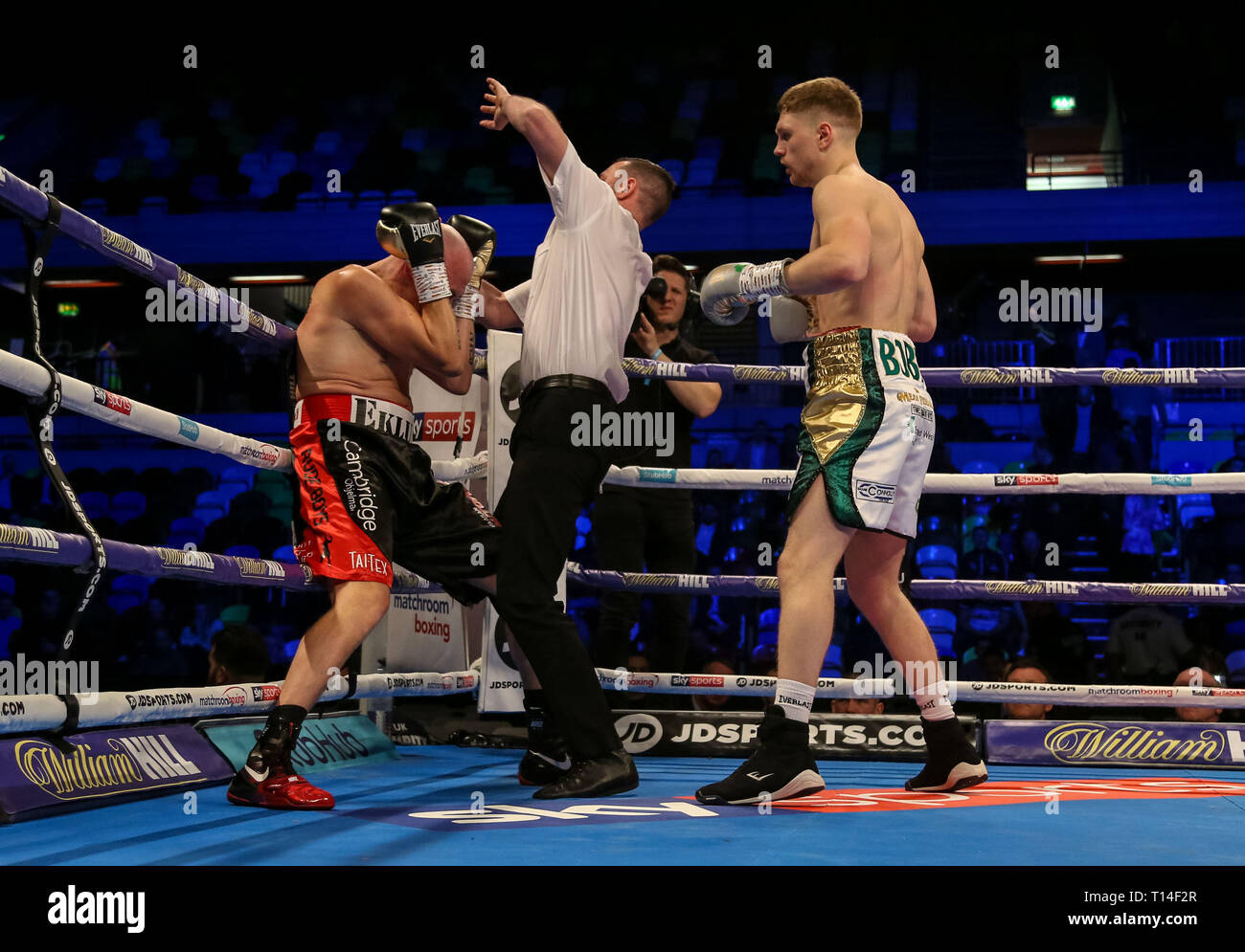 The referee stops the fight between Jason Quigley (white shorts) and