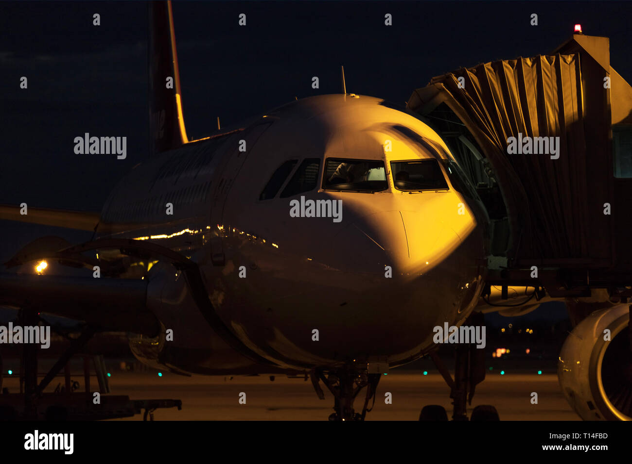 airplane at an airport at night close up Stock Photo - Alamy