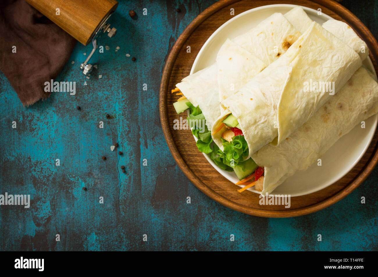 Healthy lunch snack. Tortilla wraps with grilled chicken and fresh