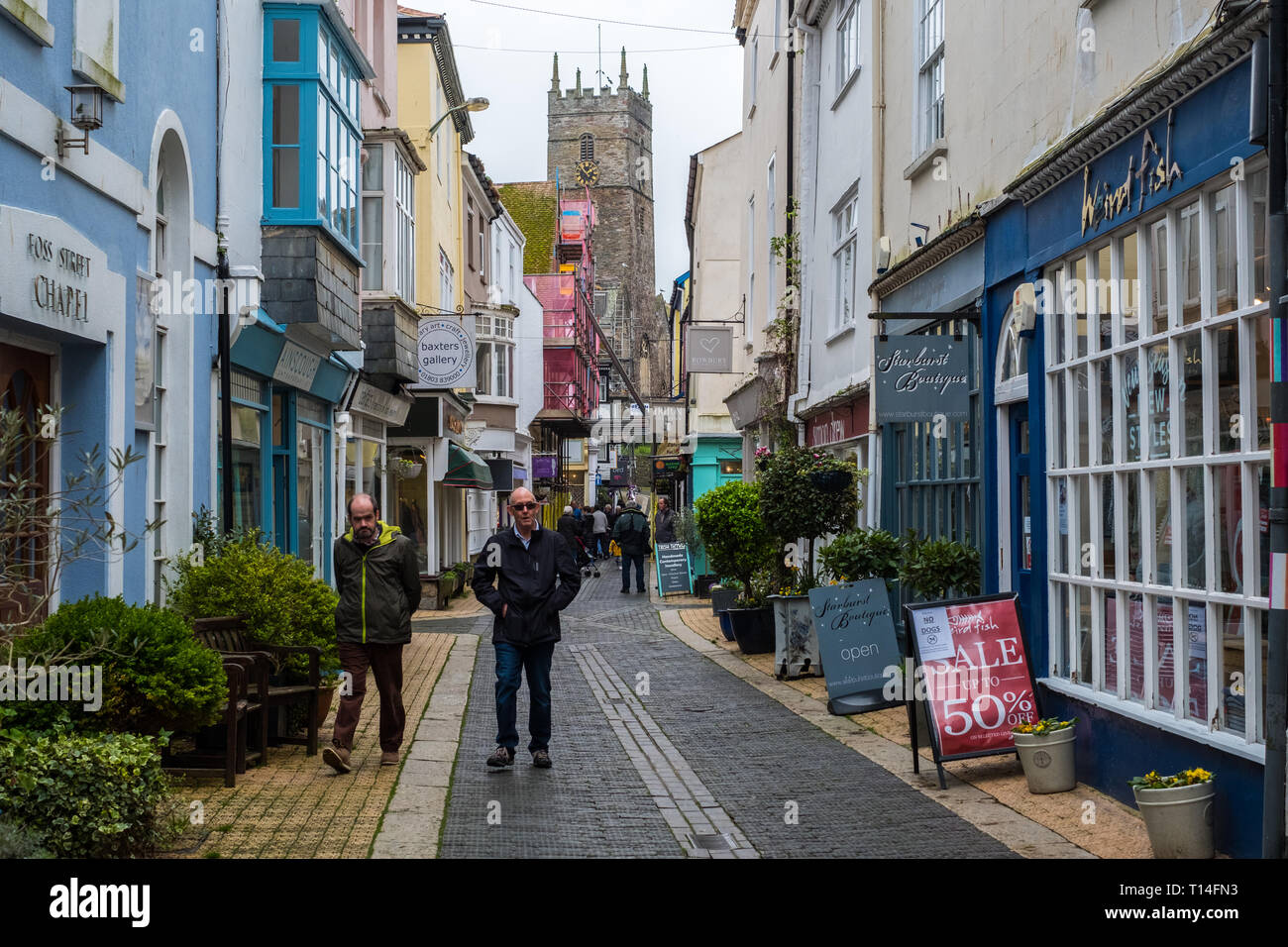 Tourists and locals wandering along Foss Street in Dartmouth, Devon, UK
