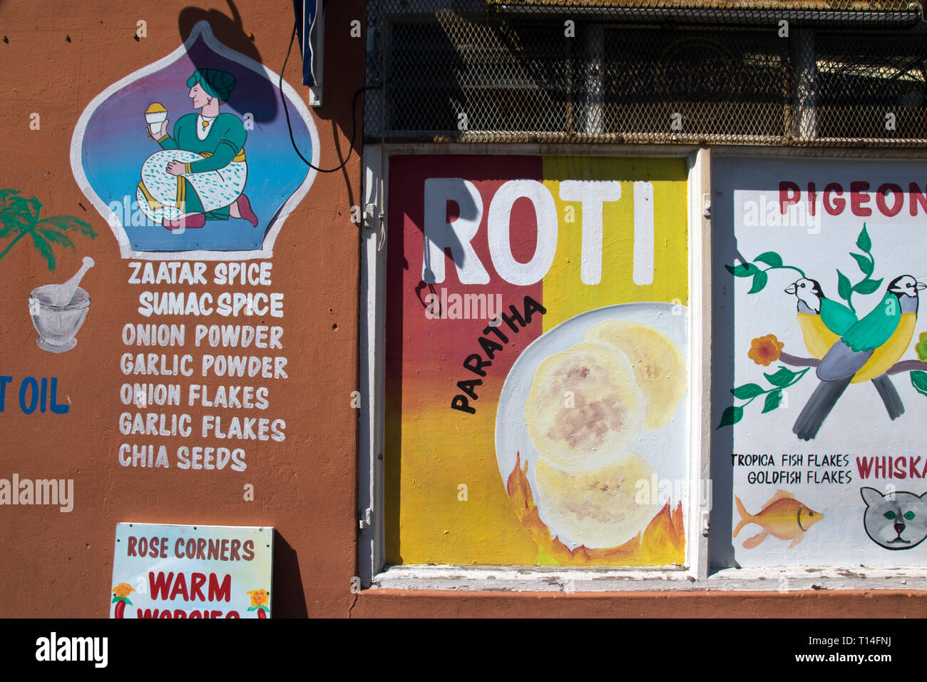Hand painted advertisement for oil and spices on a shop in the BoKaap