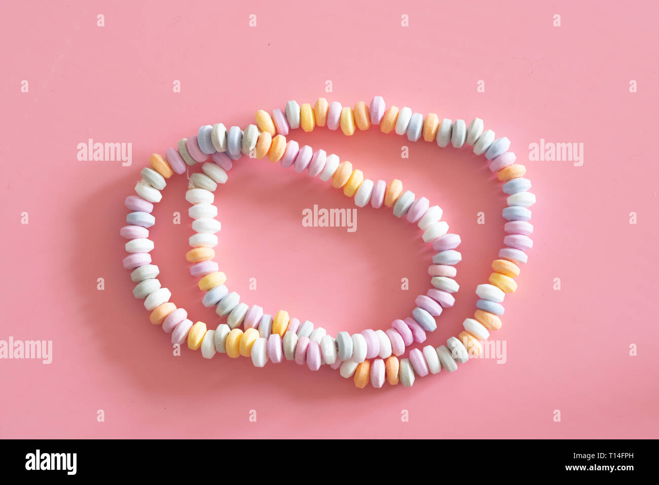 sweets Beads and bracelets candy on  pink background Stock Photo