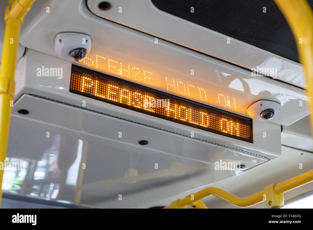 'Please Hold On' LED sign in bus Stock Photo