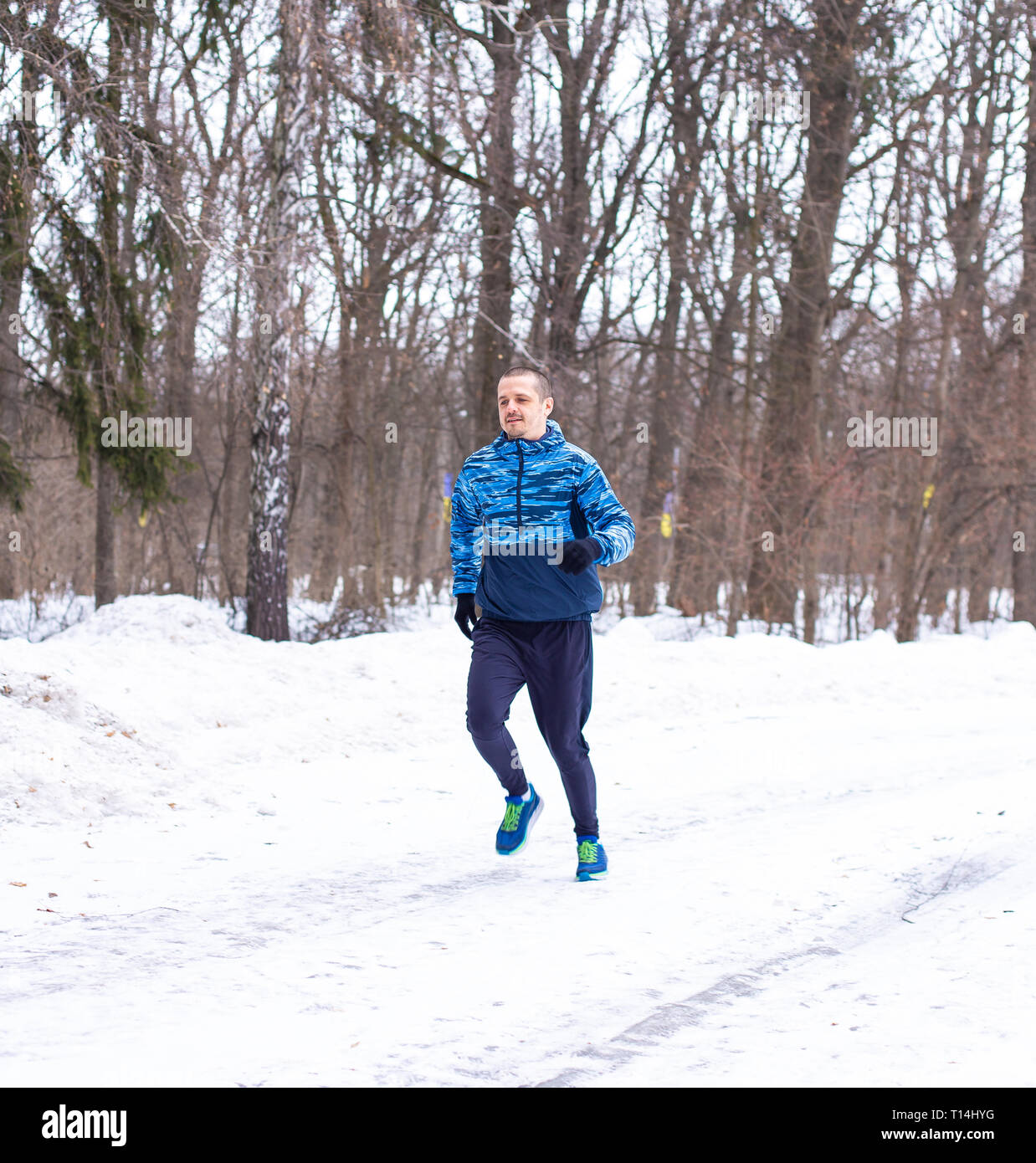 Outdoor winter running. Man runner do his training Stock Photo