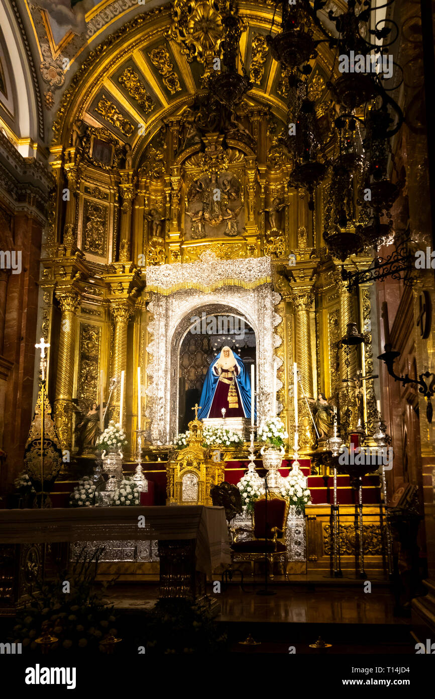 An ornate altar inside the Basilica Macarena in Seville Stock Photo