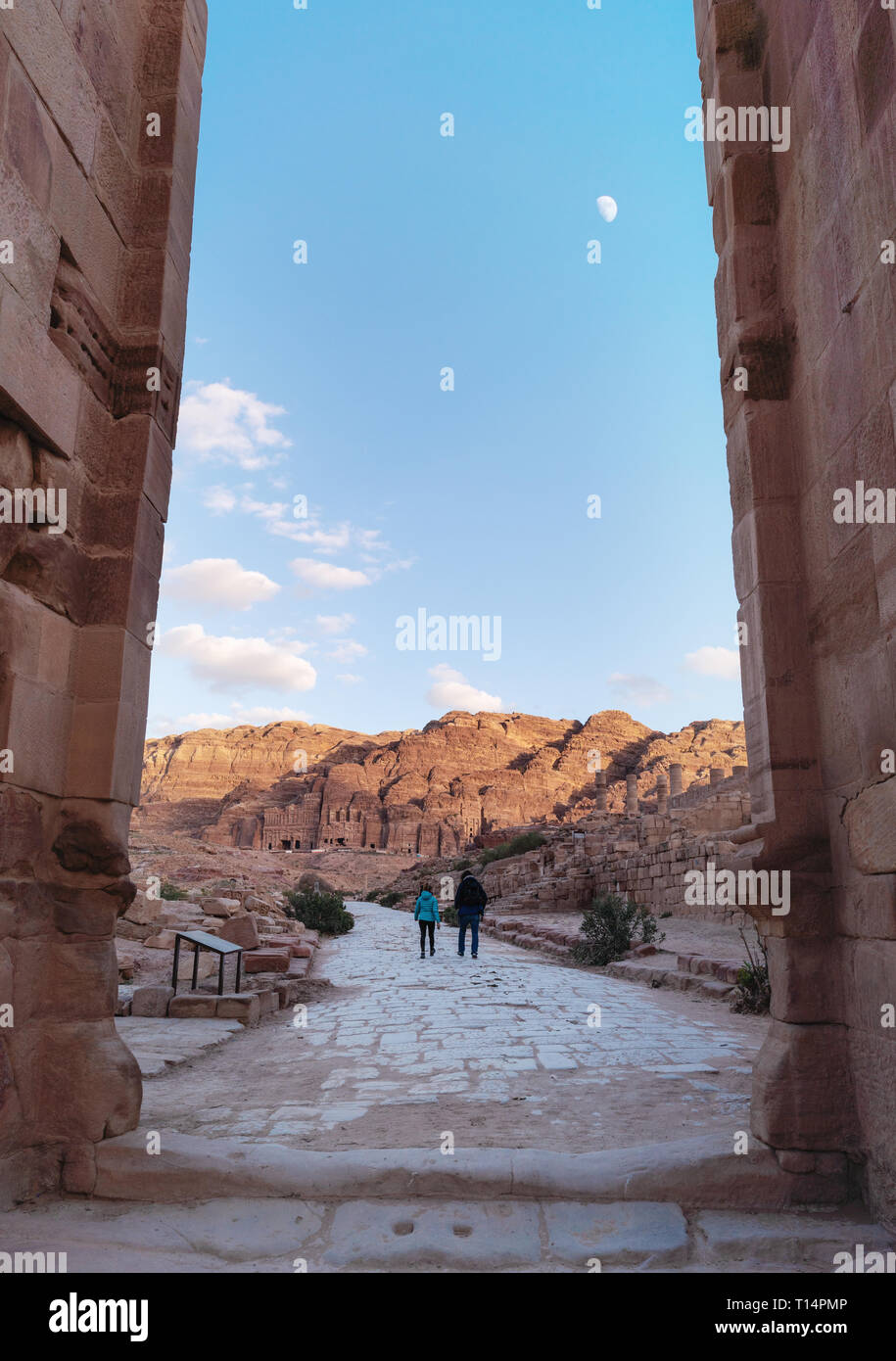 Travelling in Petra, the rose city in Jordan. Couple walking through ancient arch in Amman, Jordan, Middle East Stock Photo