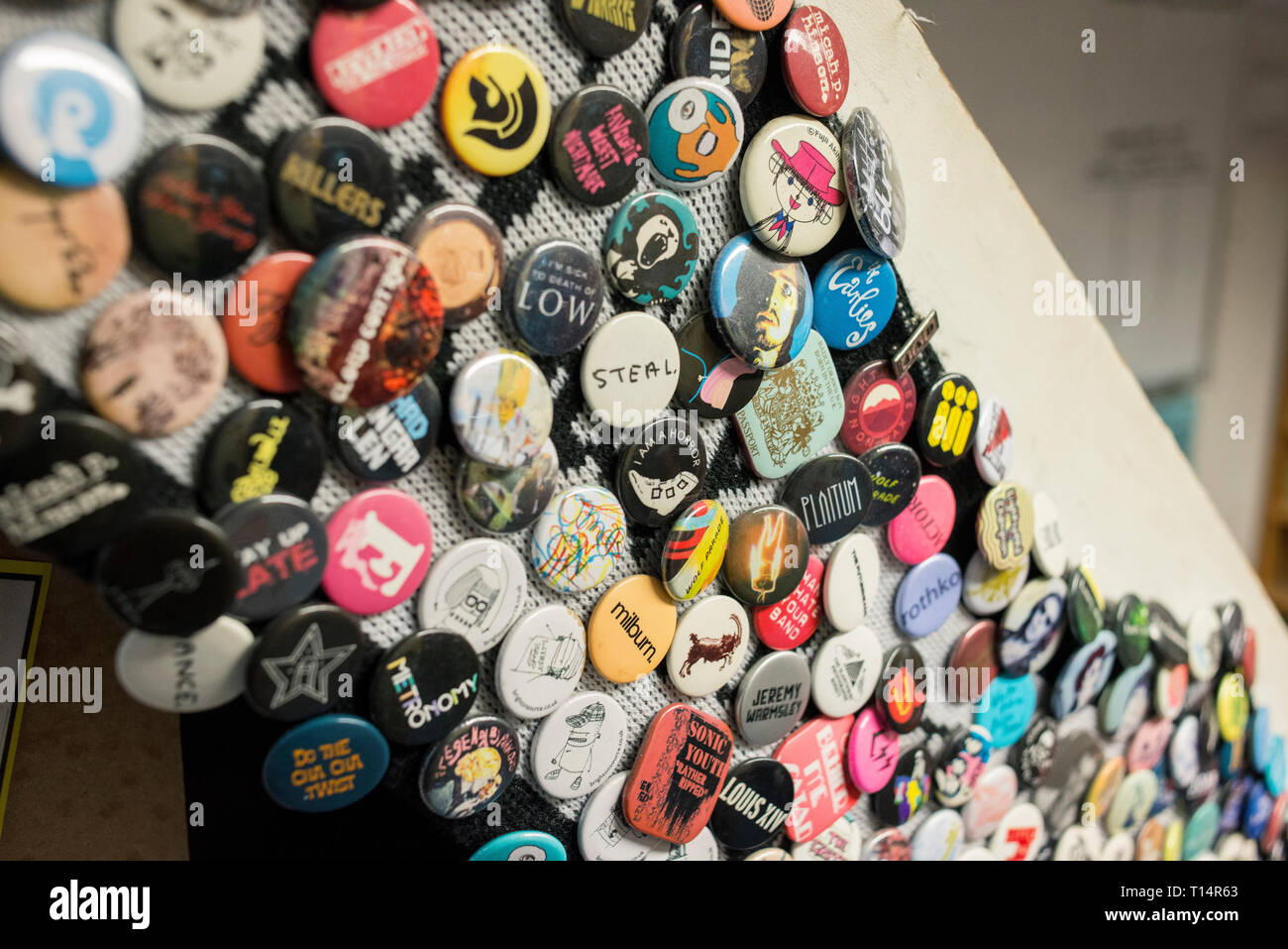 Lots of round badges on a staircase in a record shop Stock Photo