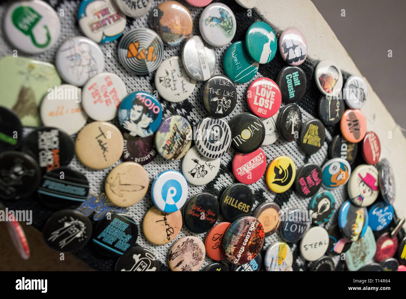 Lots of round badges on a staircase in a record shop Stock Photo