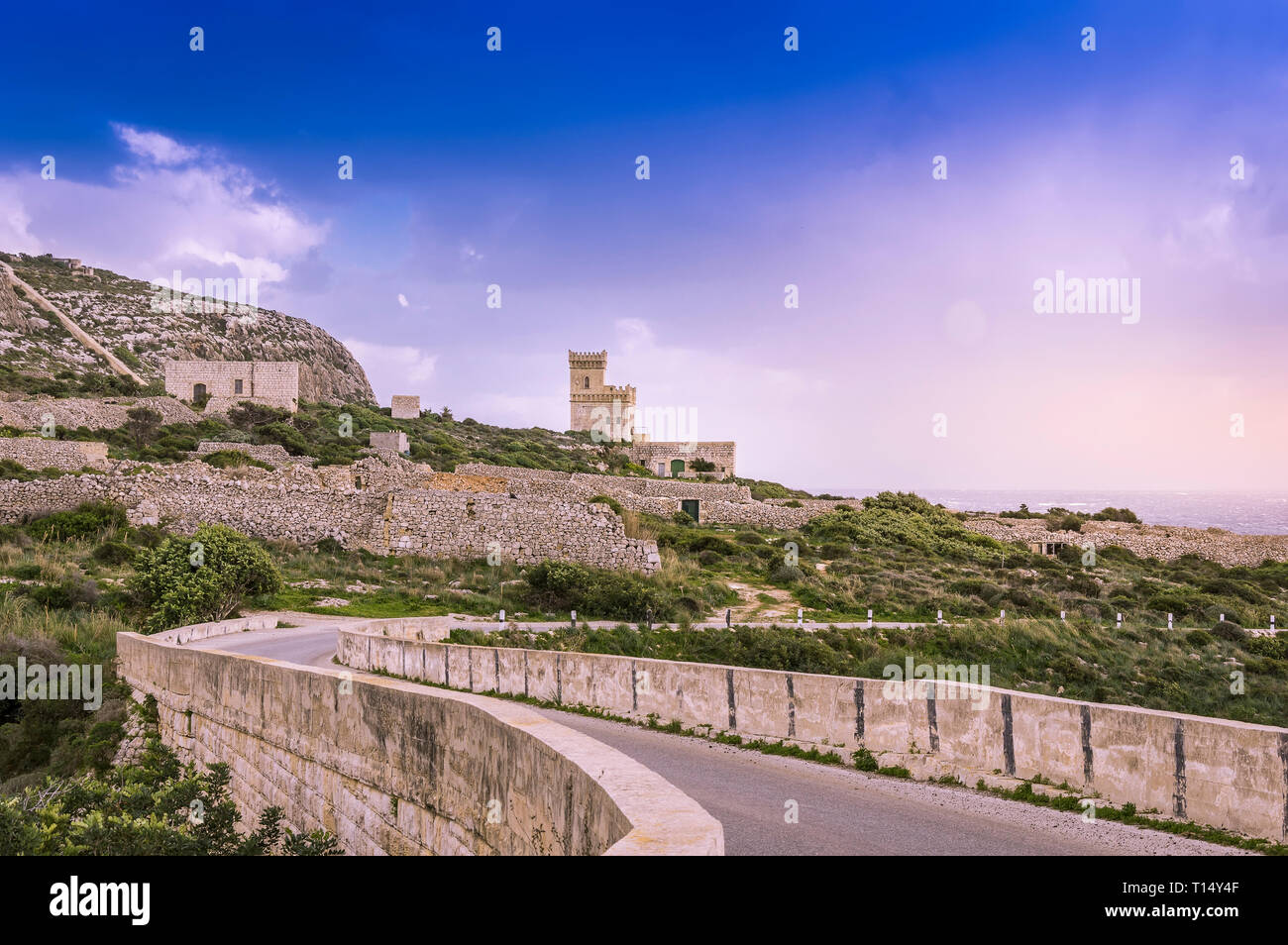 Malta Scenic road to Ghar Lapsi tower with hilly landscape and sea
