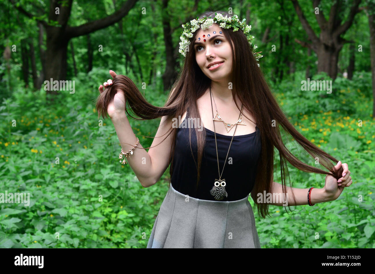 Portrait of an emotional young girl with a floral wreath on her head ...