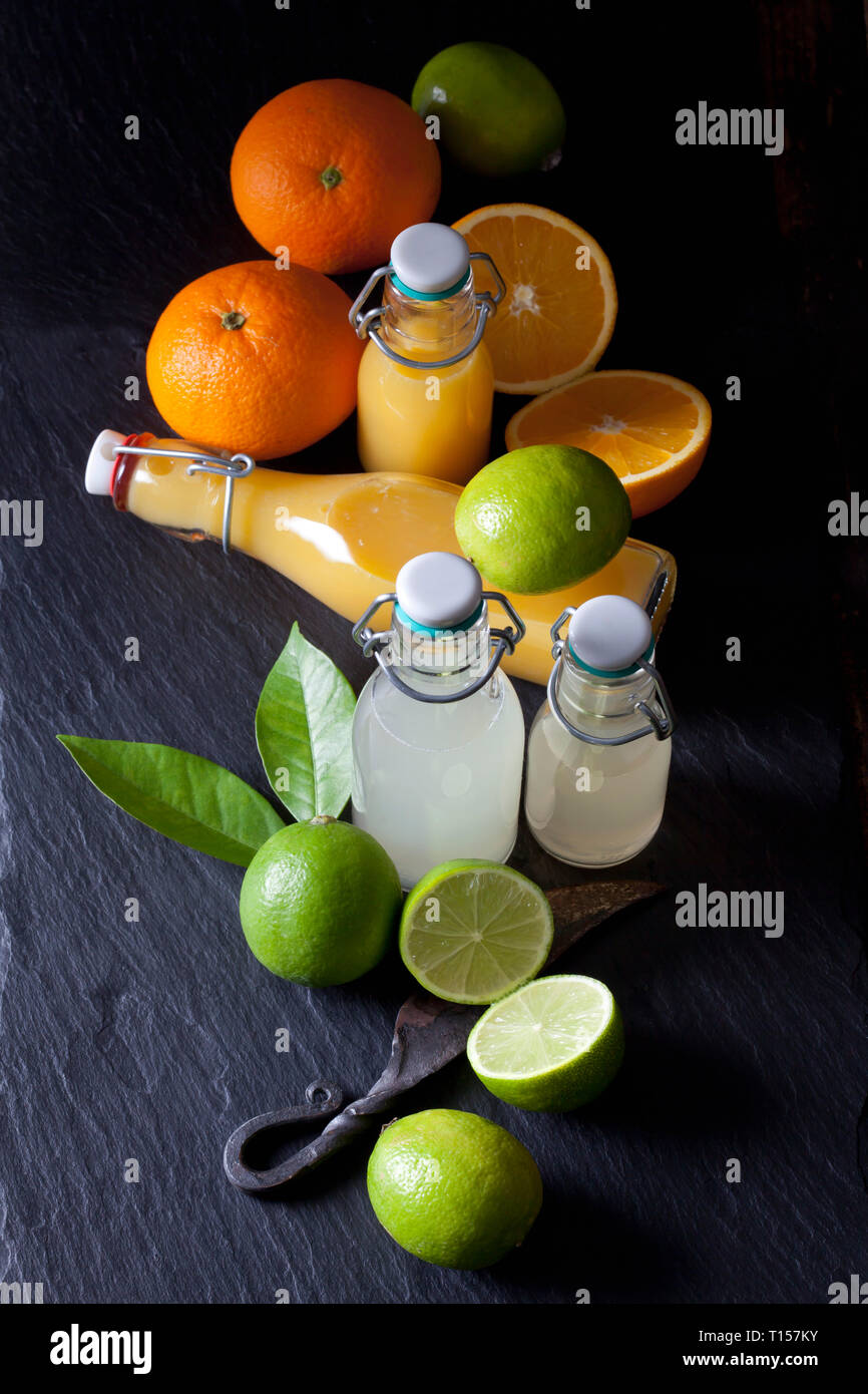 Freshly squeezed lime and orange juice in a swing top bottles Stock Photo