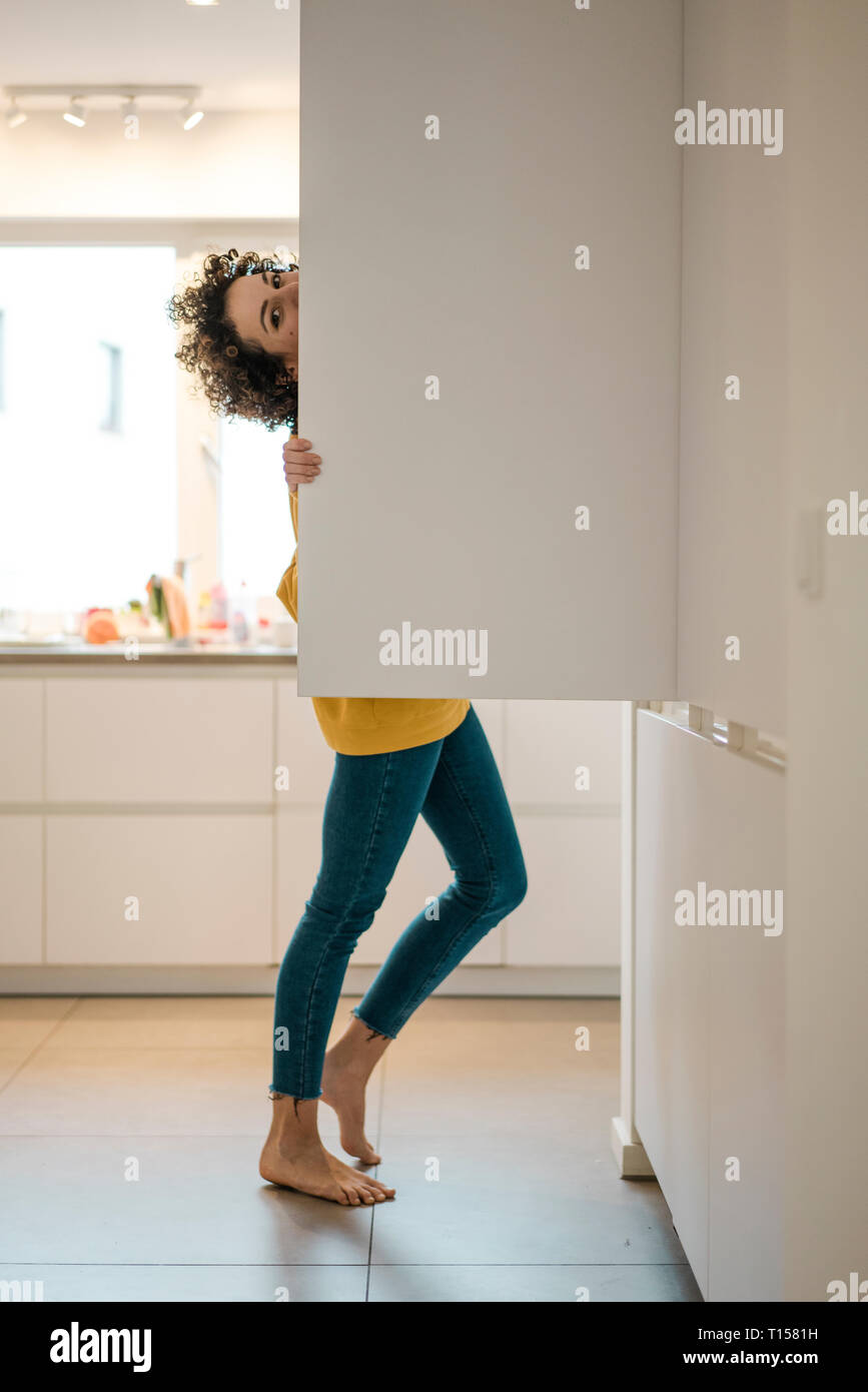 Portrait of woman at the fridge in kitchen at home Stock Photo
