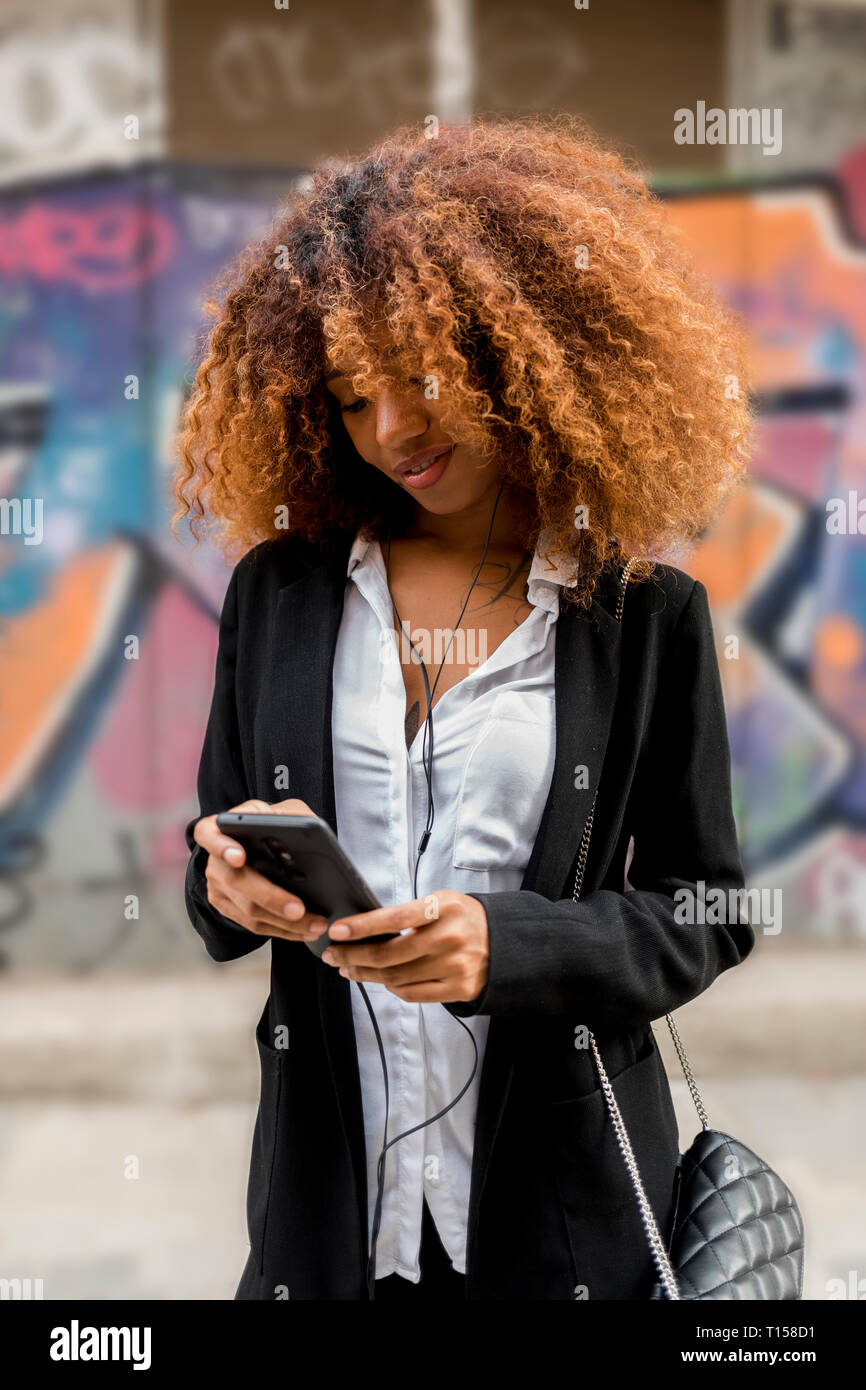 Young woman using smartphone Stock Photo