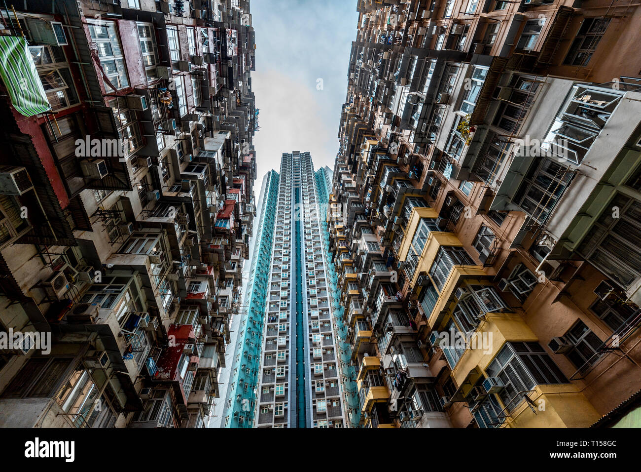 Hong Kong, Quarry Bay, apartment blocks contrasting with modern skyscraper Stock Photo