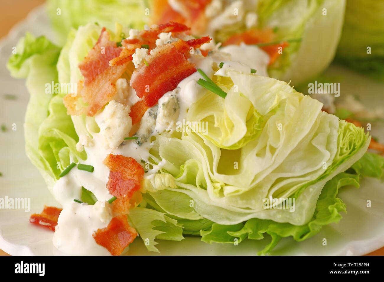 Wedge of lettuce with blue cheese dressing and bacon Stock Photo Alamy