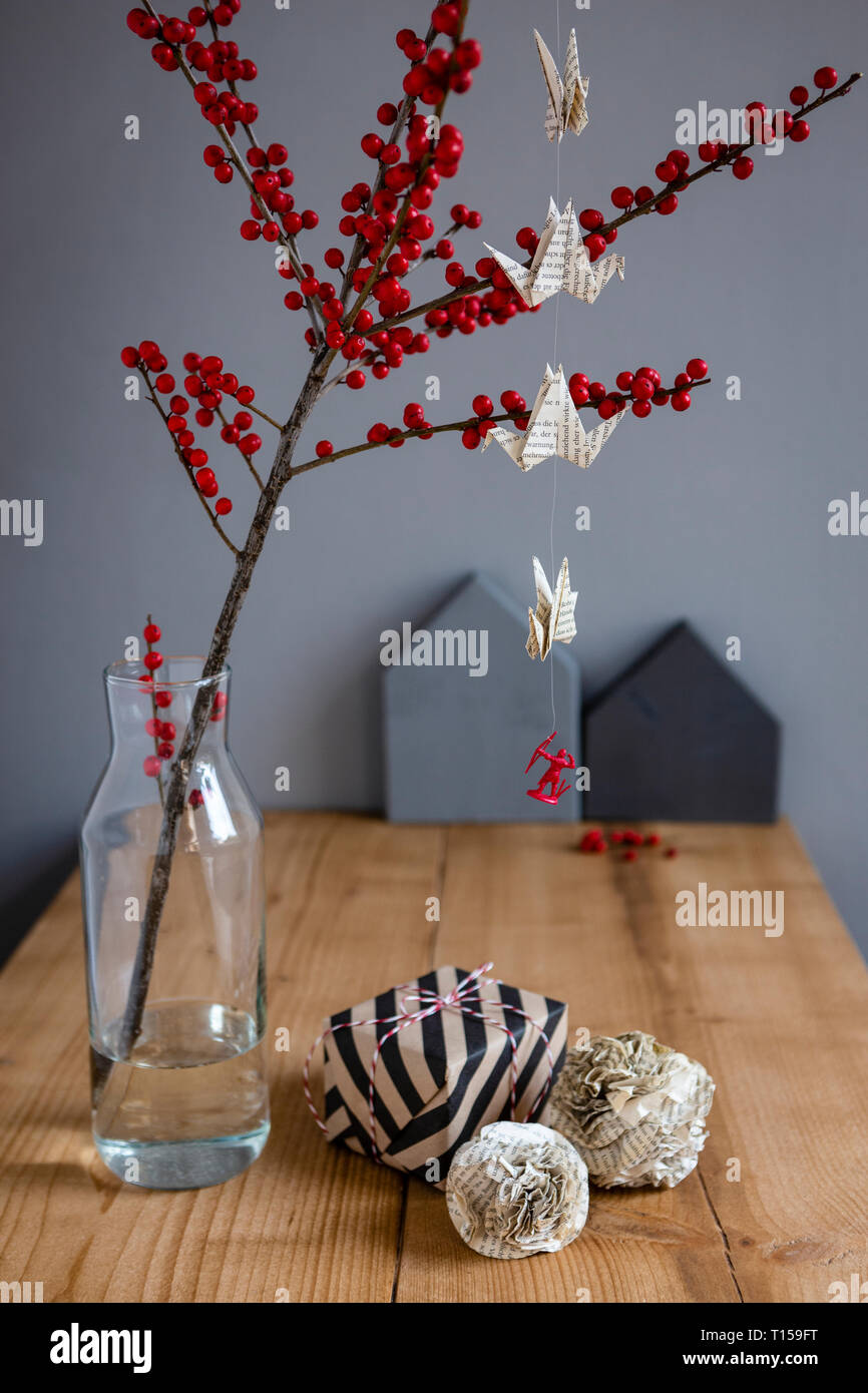Wrapped Present Paper Decoration And Twig Of Holly In Vase Stock