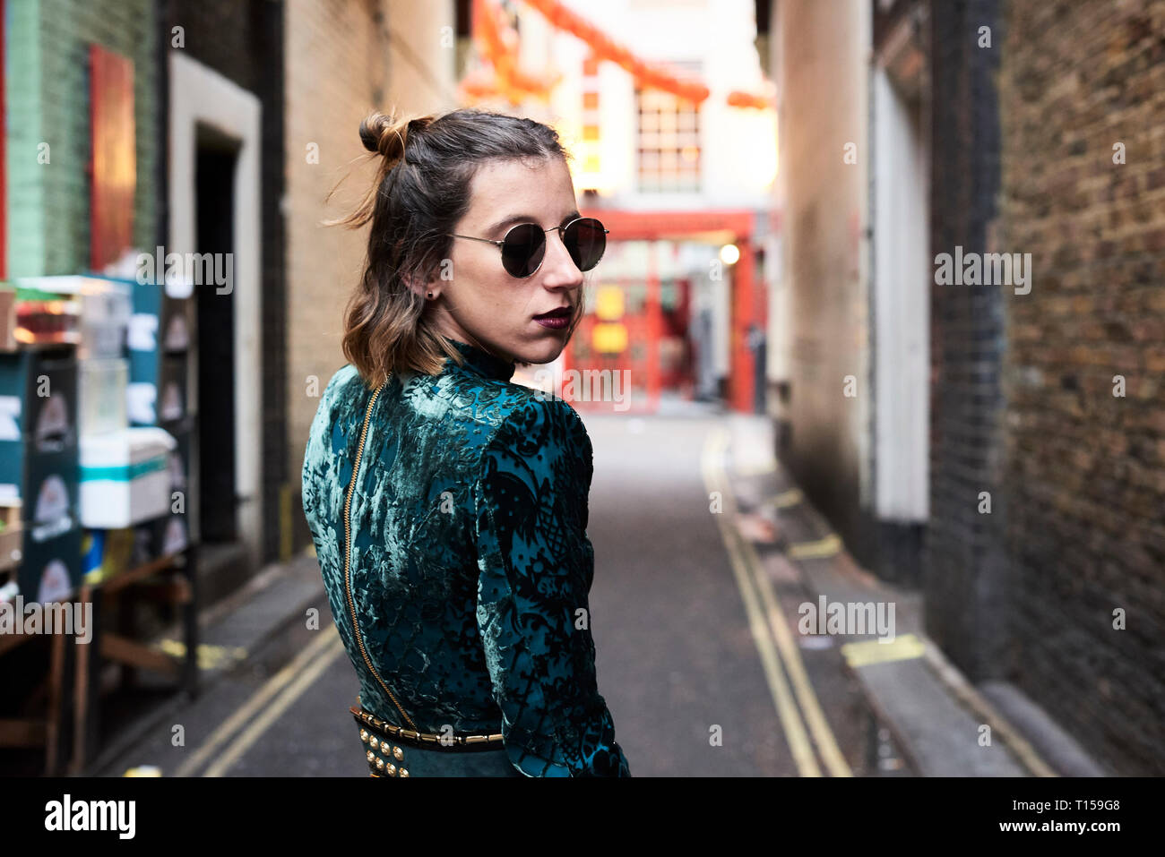 London, young woman walking in Chinatown, turning Stock Photo