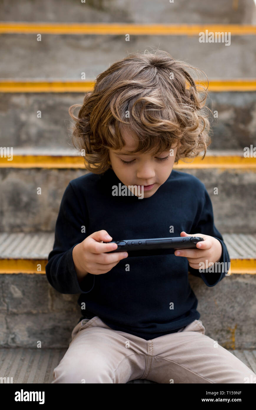 Boy playing game console hi-res stock photography and images - Alamy