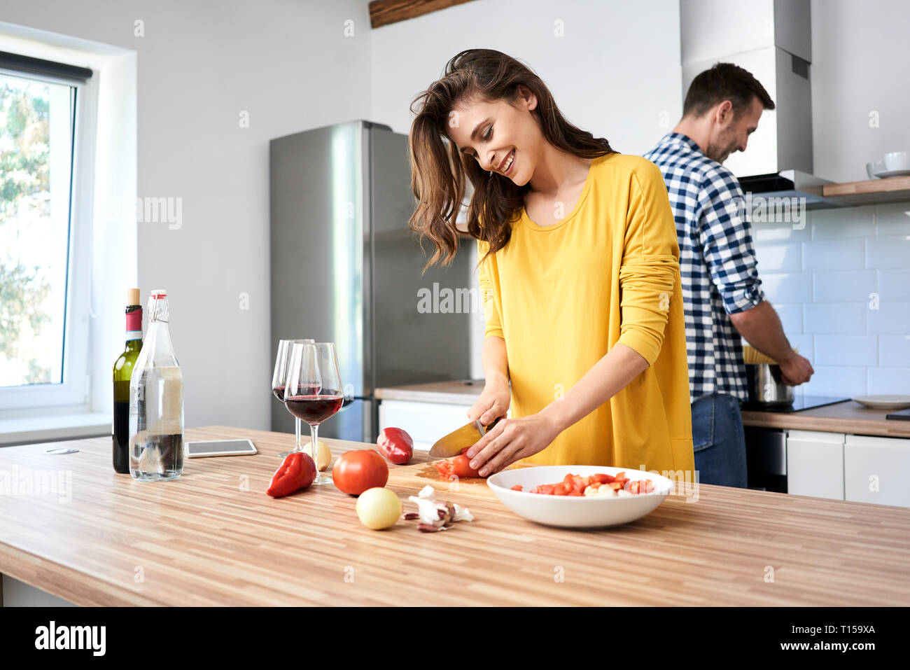 Affectionate couple in kitchen, preparing spaghetti toghether Stock Photo