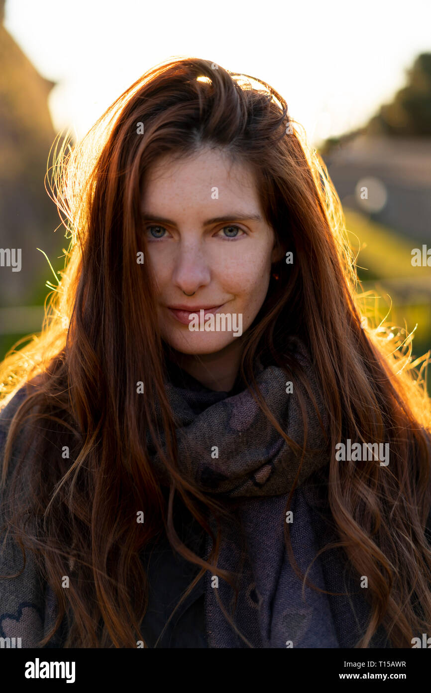 Portrait of smiling young woman with nose piercing in autumn Stock Photo