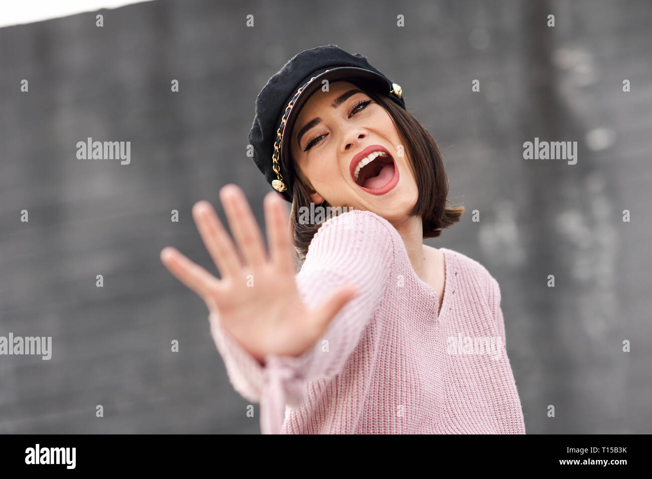 Portrait of posing young woman wearing cap Stock Photo