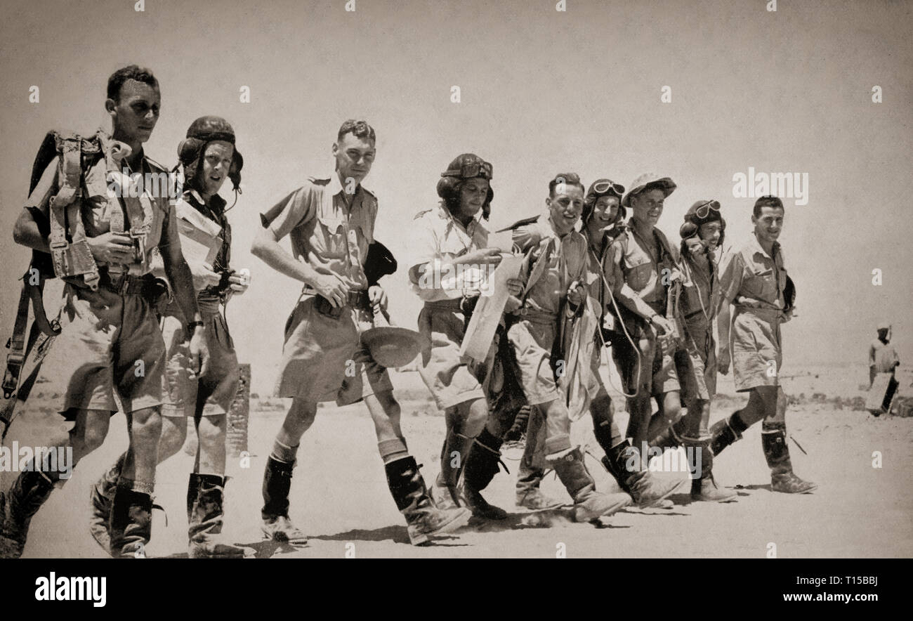 Bomber crews in hot weather outfits walking out to their aircraft prior to a raid over the African desert. The North African Campaign of the Second World War took place from June 1940 to May 1943 and included campaigns fought in the Libyan and Egyptian deserts (Western Desert Campaign, also known as the Desert War) and in Morocco and Algeria (Operation Torch), as well as Tunisia (Tunisia Campaign). Stock Photo