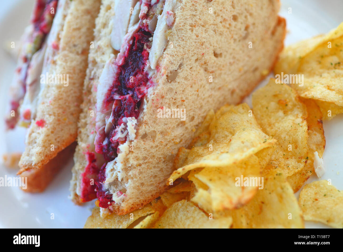 Turkey sandwich cut in half with stuffingflavored potato chips Stock