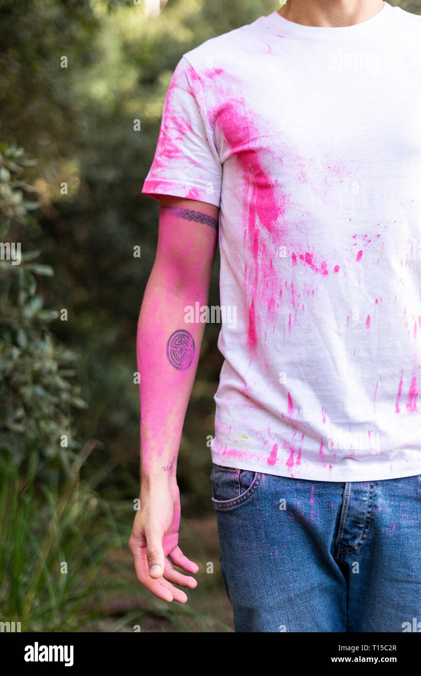 Mid adult man full of colorful powder paint, celebrating Holi, Festival of Colors Stock Photo