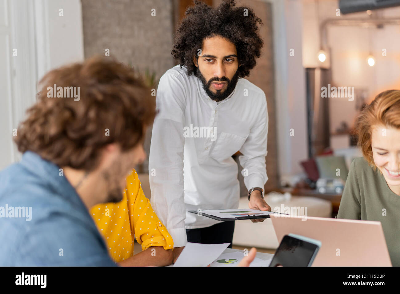 Young business poeple having a meeting in coworking space Stock Photo