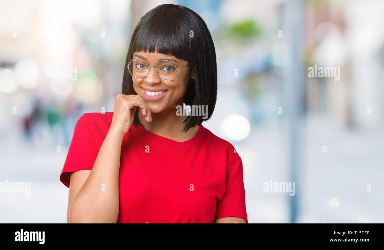 Beautiful young african american woman wearing glasses over isolated ...