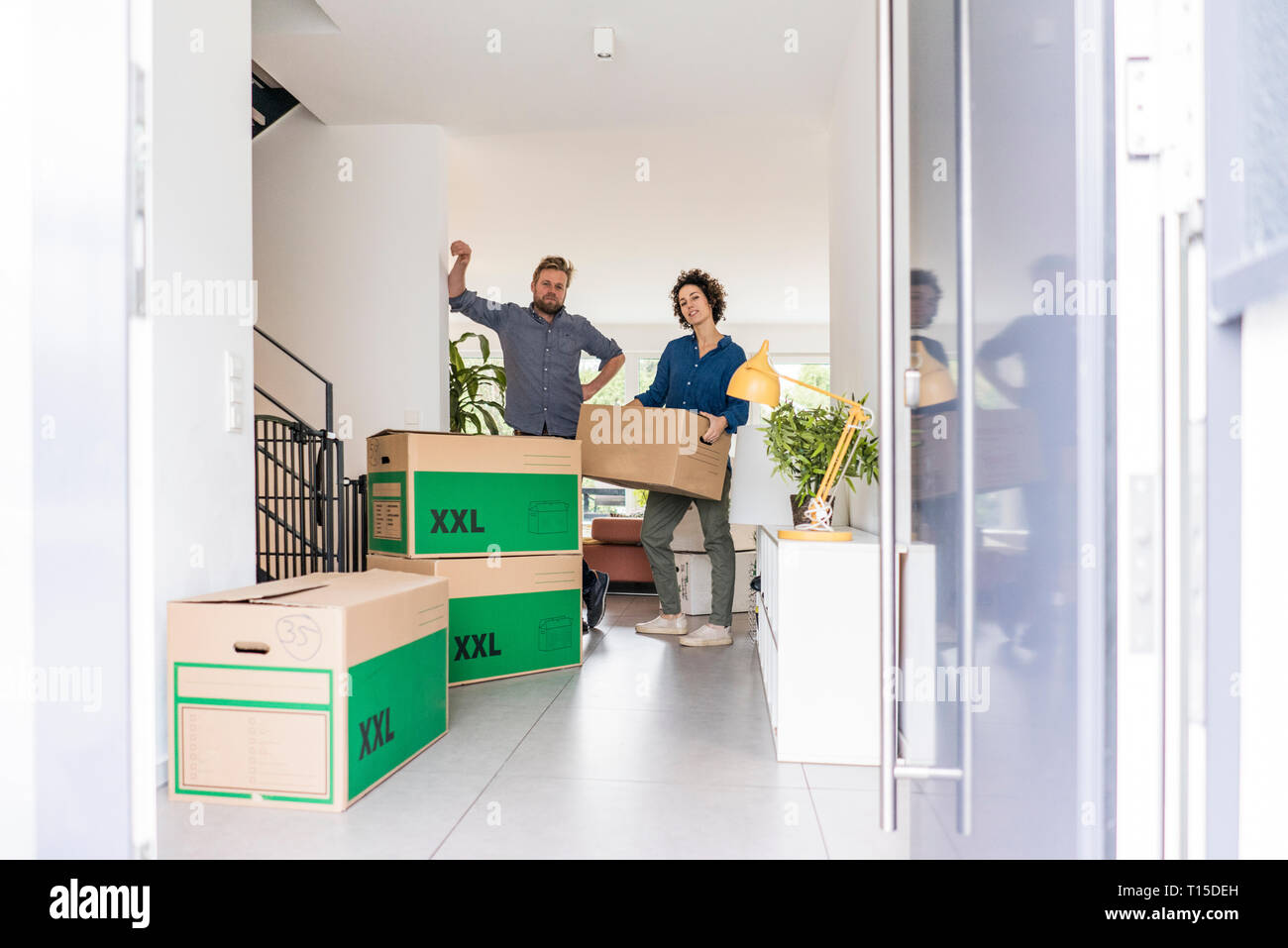 Portrait of couple in new home with cardboard boxes Stock Photo - Alamy
