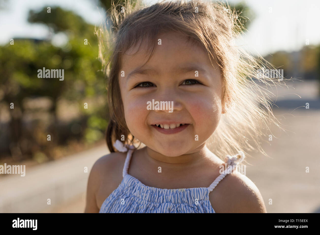 Portrait of happy little girl outdoors Stock Photo - Alamy