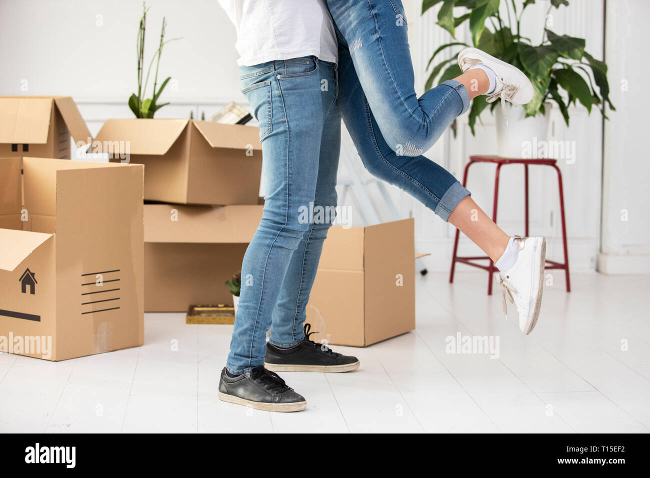 Hugging Boxes Close-up of happy ouple with cardboard boxes hugging in new home Stock ...