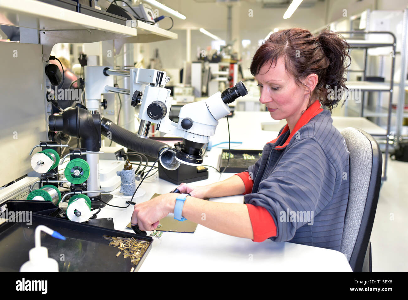 Woman working on quality control in the manufacturing of circuit boards for the electronics industry Stock Photo