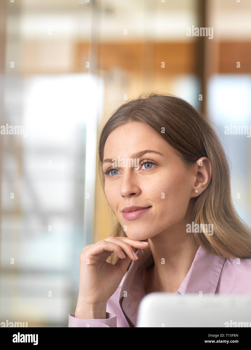 Confident businesswoman in office thinking Stock Photo
