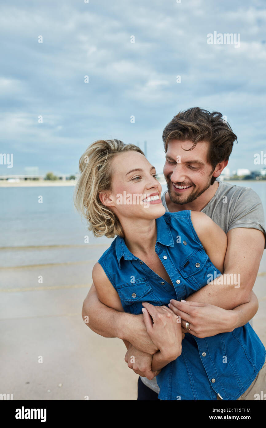 Happy young couple hugging hi-res stock photography and images - Alamy