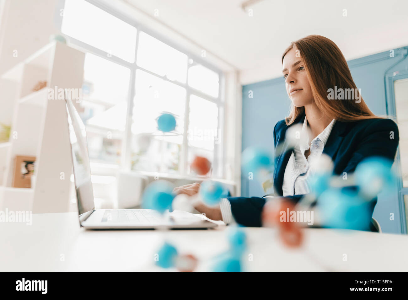 Female scientist studying molecule model Stock Photo