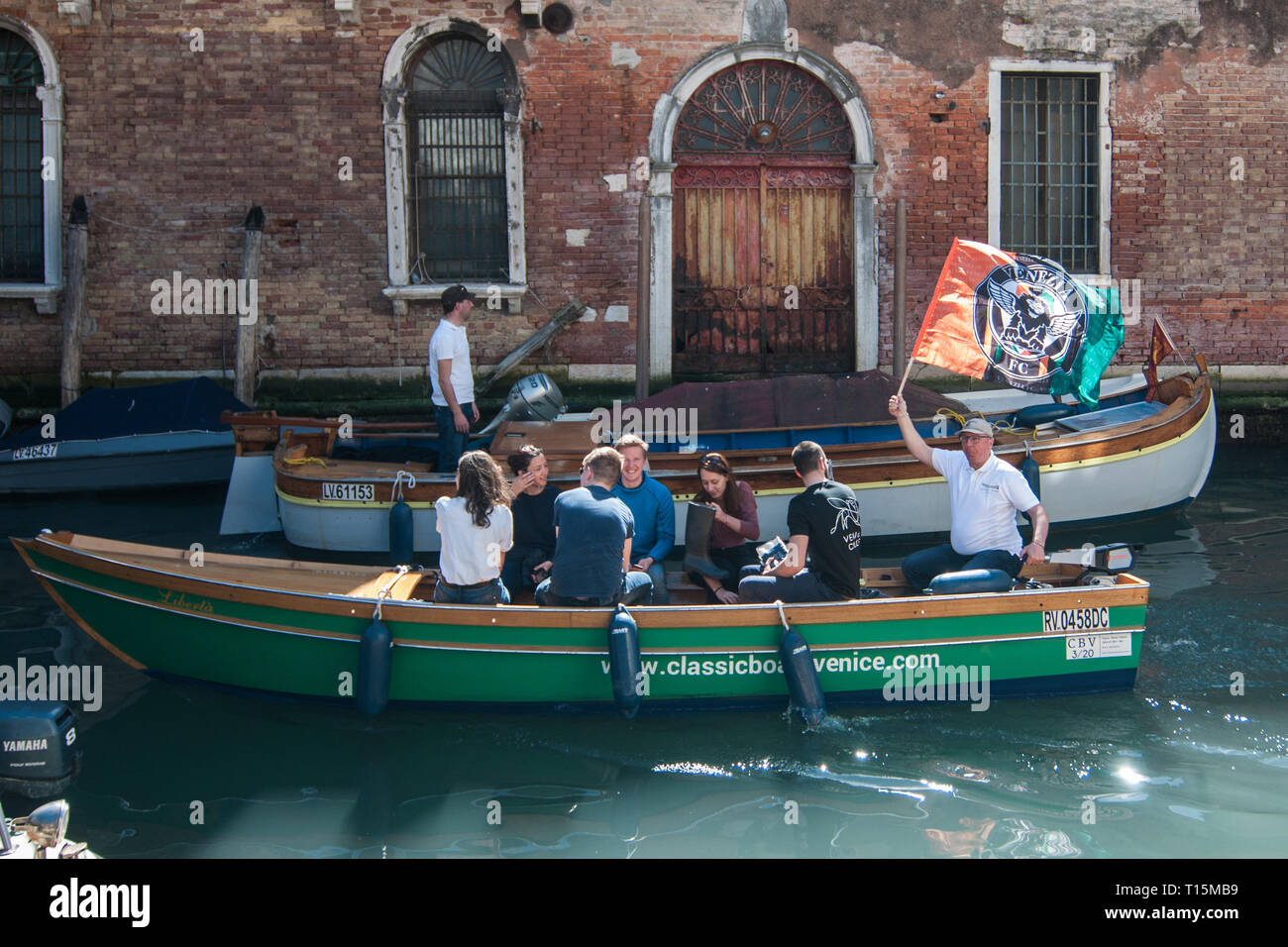 Venice, Italy - 23th March, 2019. An electric boat start to go to clean a designated site of the shoals of the city on 23 March 2019, in Venice Italy. 'Kick Plastic Out' is an event organized by Classic Boats Venice and the 'Venice Calls' youth association, and it is a day dedicated to cleaning canals and shoals adjacent to the historic city of Venice using only electric propulsion boats or oars, an initiative launched by young people to help clean the Venetian lagoon. © Simone Padovani / Awakening / Alamy Live News Stock Photo