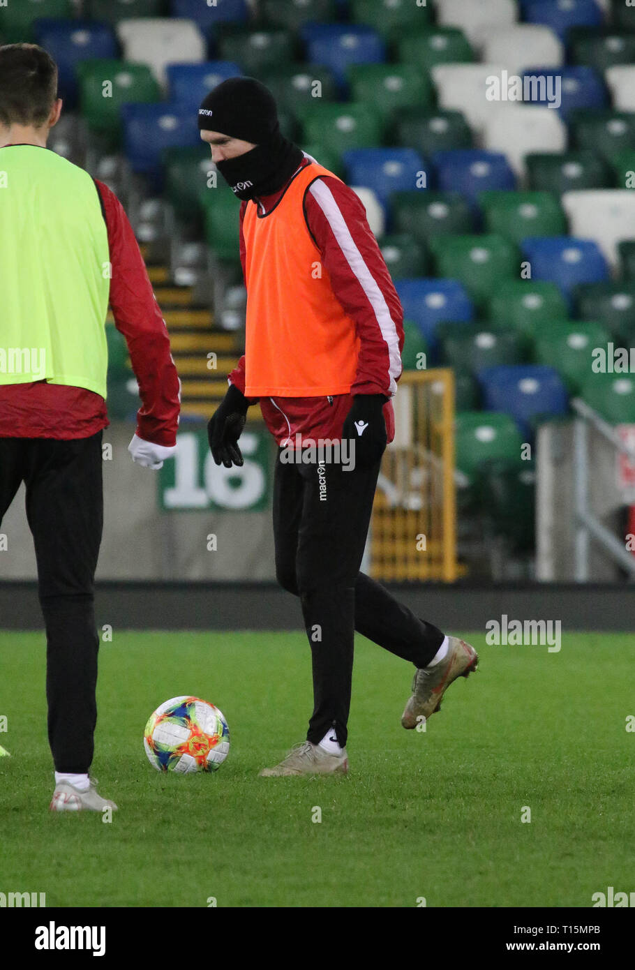 Windsor Park Belfast, Northern Ireland, UK. 23 March 2019. The Belarus squad train at Windsor Park before their game against Northern Ireland tomorrow night. Alexander Hleb training (hat and snood). Credit: David Hunter/Alamy Live News.. Stock Photo