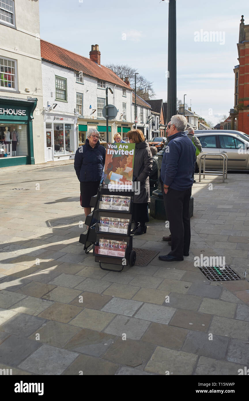 Jehovahs witnesses with a stand of Awake! magazines in Beverley Market, Saturday Market, East Yorkshire, March 23rd 2019, England, UK, GB. Credit: Alan Mather/Alamy Live News Stock Photo