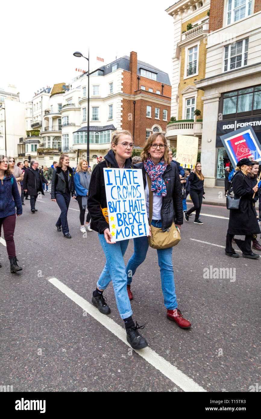 London, UK. 23rd Mar 2019. Over a million people march for the People's  Vote, for a second referendum on Brexit, two women marching, one holding a 'I  Hate Crowds but I Hate