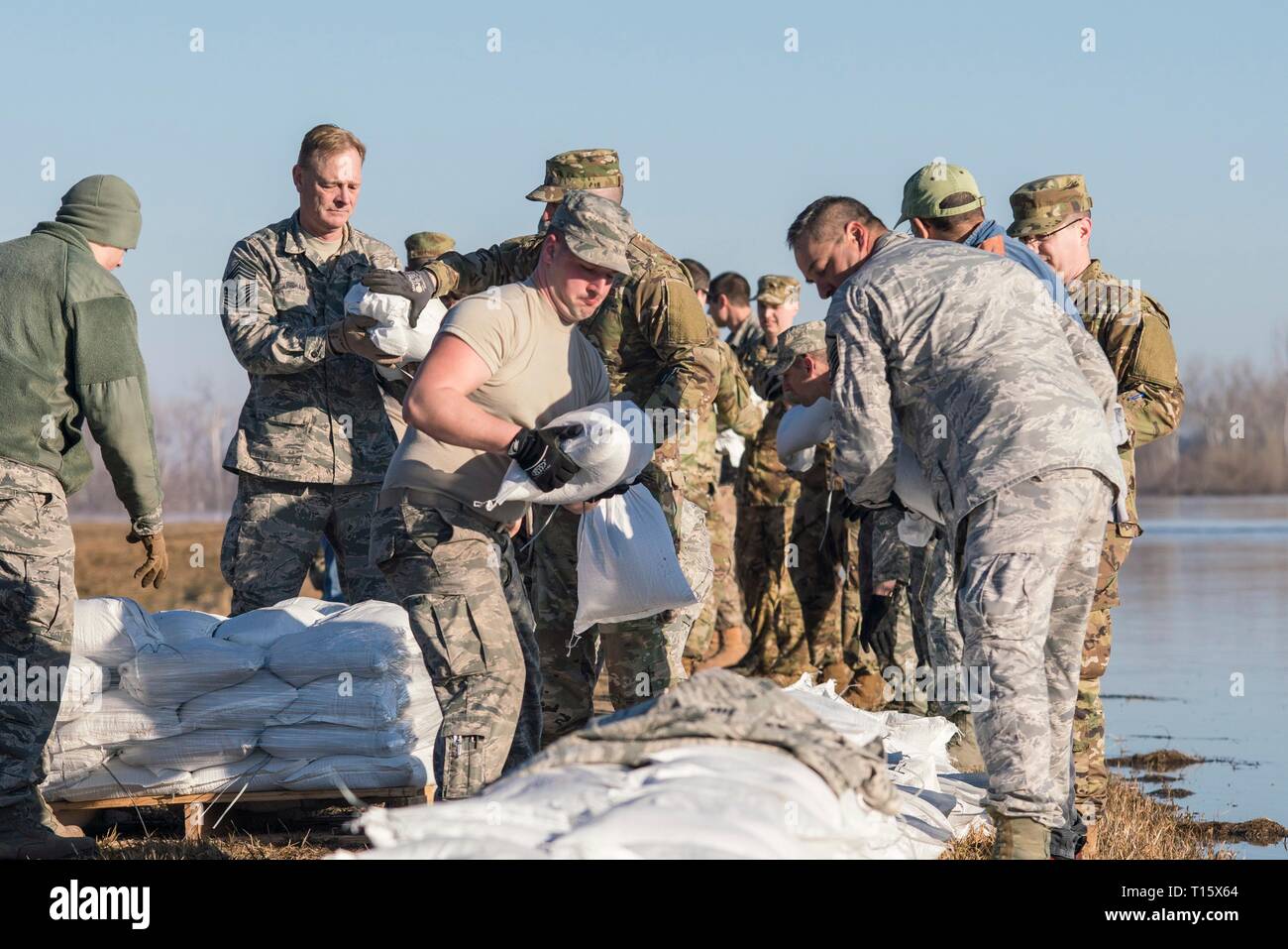 Missouri Air National Guard airmen stack sandbags to reinforce the levee that protects Rosecrans Memorial Airport March 22, 2019 in . Historic flooding caused by rapid melting of record snowfall sweep through rural communities in Nebraska, Iowa, Kansas and Missouri killing at least four people and causing widespread destruction. Stock Photo