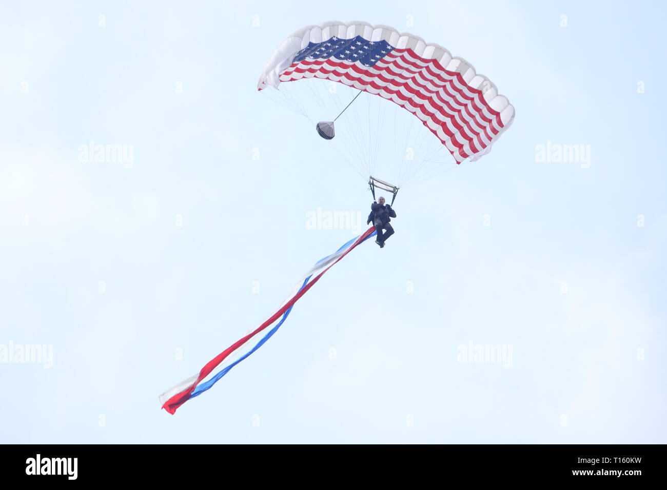 California, USA. 23rd Mar, 2019. 23rd March, 2019   Salinas, California, USA      Scenes from the annual  Salinas Air-Show, featuring the US Navy 'Blue Angels' arobatic team:  Here the parachute opening drop with accompanying USA flag Credit: Motofoto/Alamy Live News Stock Photo