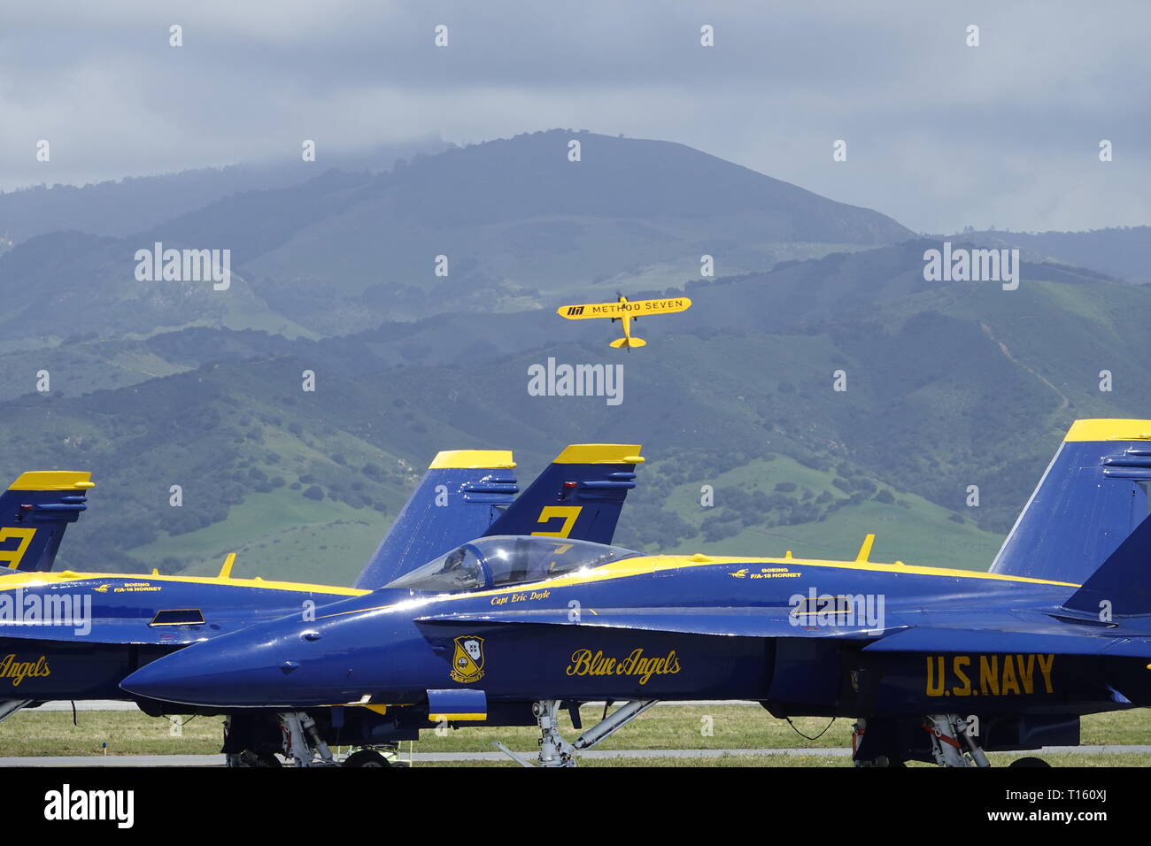 California, USA. 23rd Mar, 2019. 23rd March, 2019   Salinas, California, USA      Scvenes from the annual  Salinas Air-Show, featuring the US Navy 'Blue Angels' arobatic team: here Eric tucker in his 'Method seven' high wing maneouvers over the jets of the Blue Angels Credit: Motofoto/Alamy Live News Stock Photo