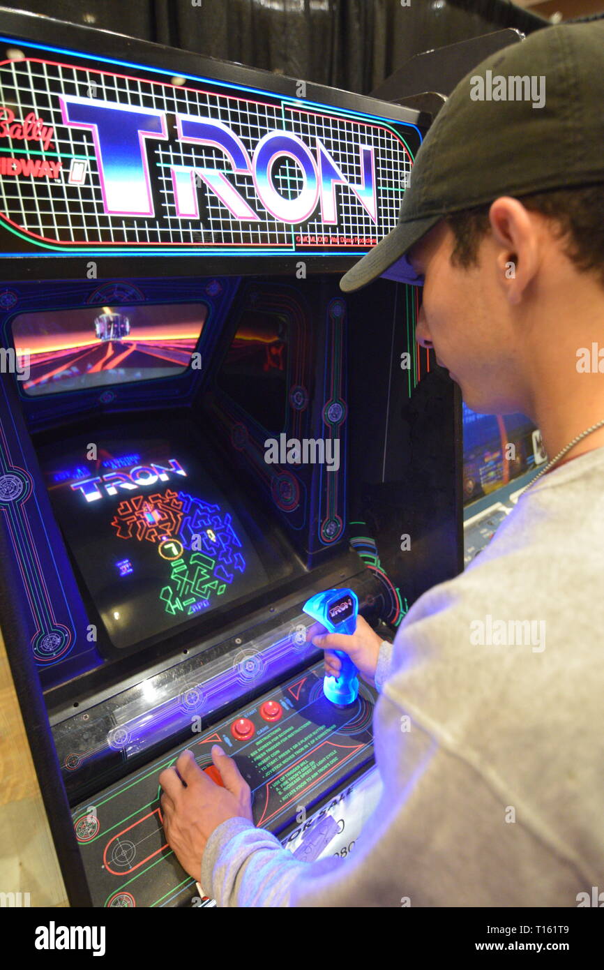 Frisco, USA. 23rd March, 2019. A young man playing a vintage Tron game