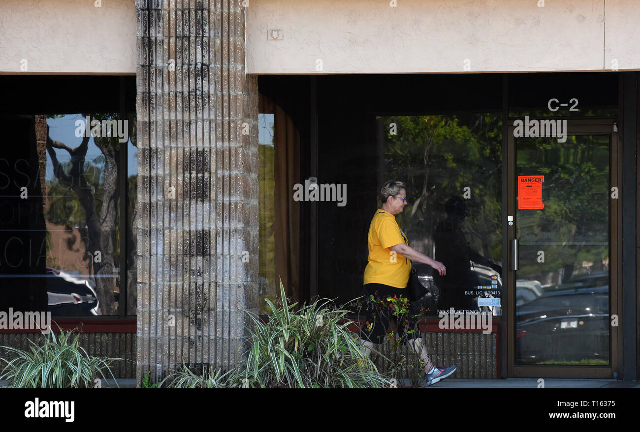 Florida, USA. 22nd Mar, 2019. A woman walks past the site of the former Orchids of Asia Day Spa in Jupiter, Florida on March 22, 2019, where New England Patriots owner Robert Kraft and others were allegedly caught soliciting prostitution last month. The business has closed and most signage has been removed. The nearby Cur Salt Spa, which is in the same shopping plaza, is being mistaken for the Orchids of Asia Day Spa by curiosity seekers who are stopping to take photos and selfies in front of the business. Credit: Paul Hennessy/Alamy Stock Photo