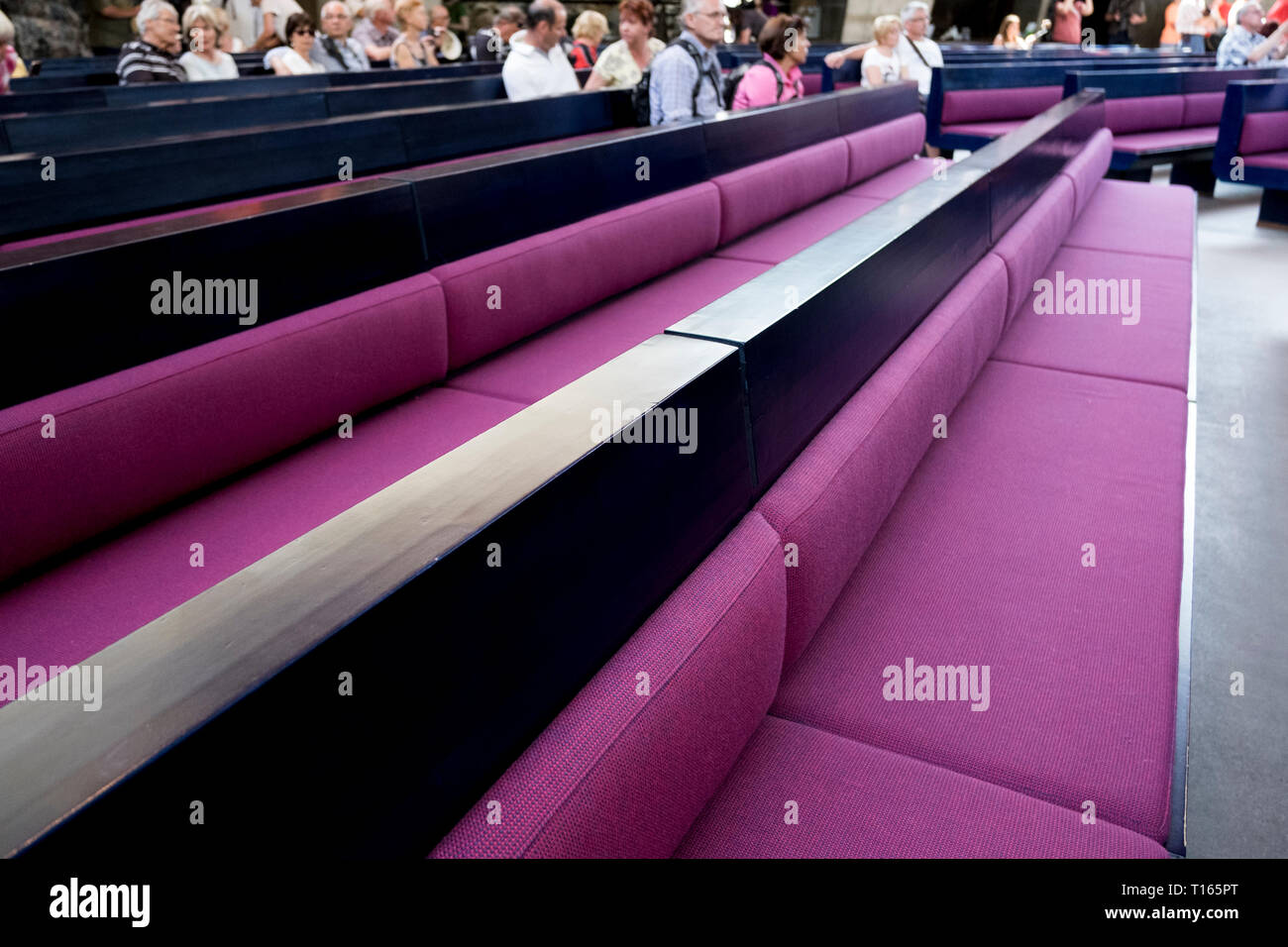 A look at the lovely purple cushions on the benches, pews of Temppeliaukio Lutheran church in Helsinki, Finland. The church was built in 1969. Stock Photo