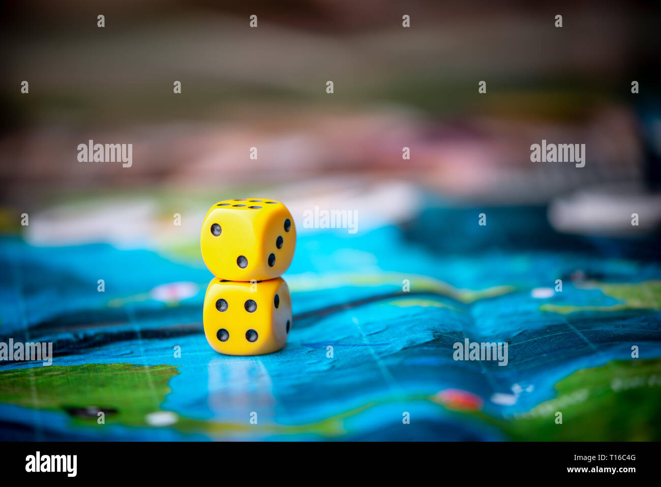 Yellow dice game on the blue field of fantasy game. Luck and excitement. Concept Board games strategy Stock Photo