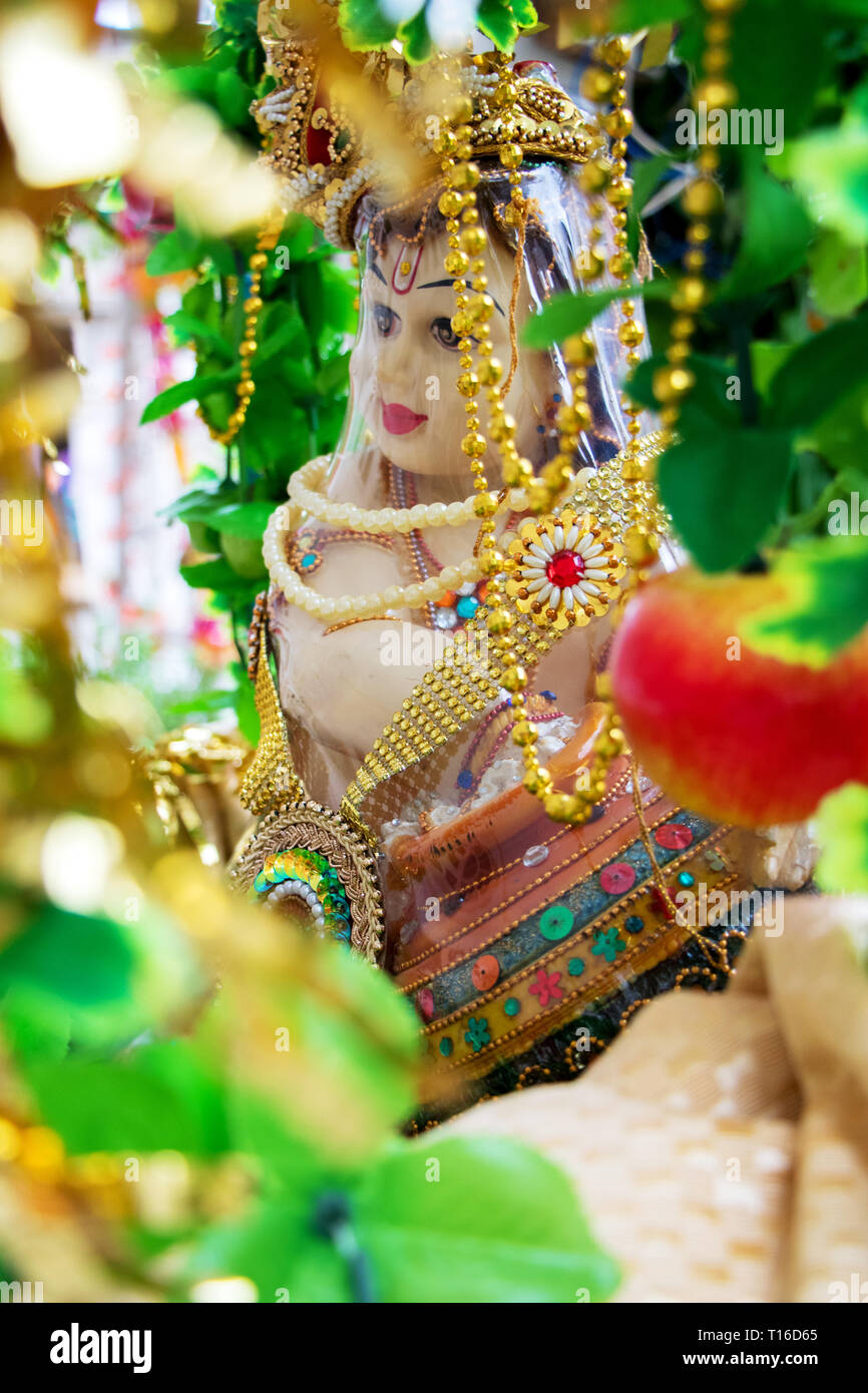 The Hindu God, Lord Krishna, in his childhood form, eating butter ...