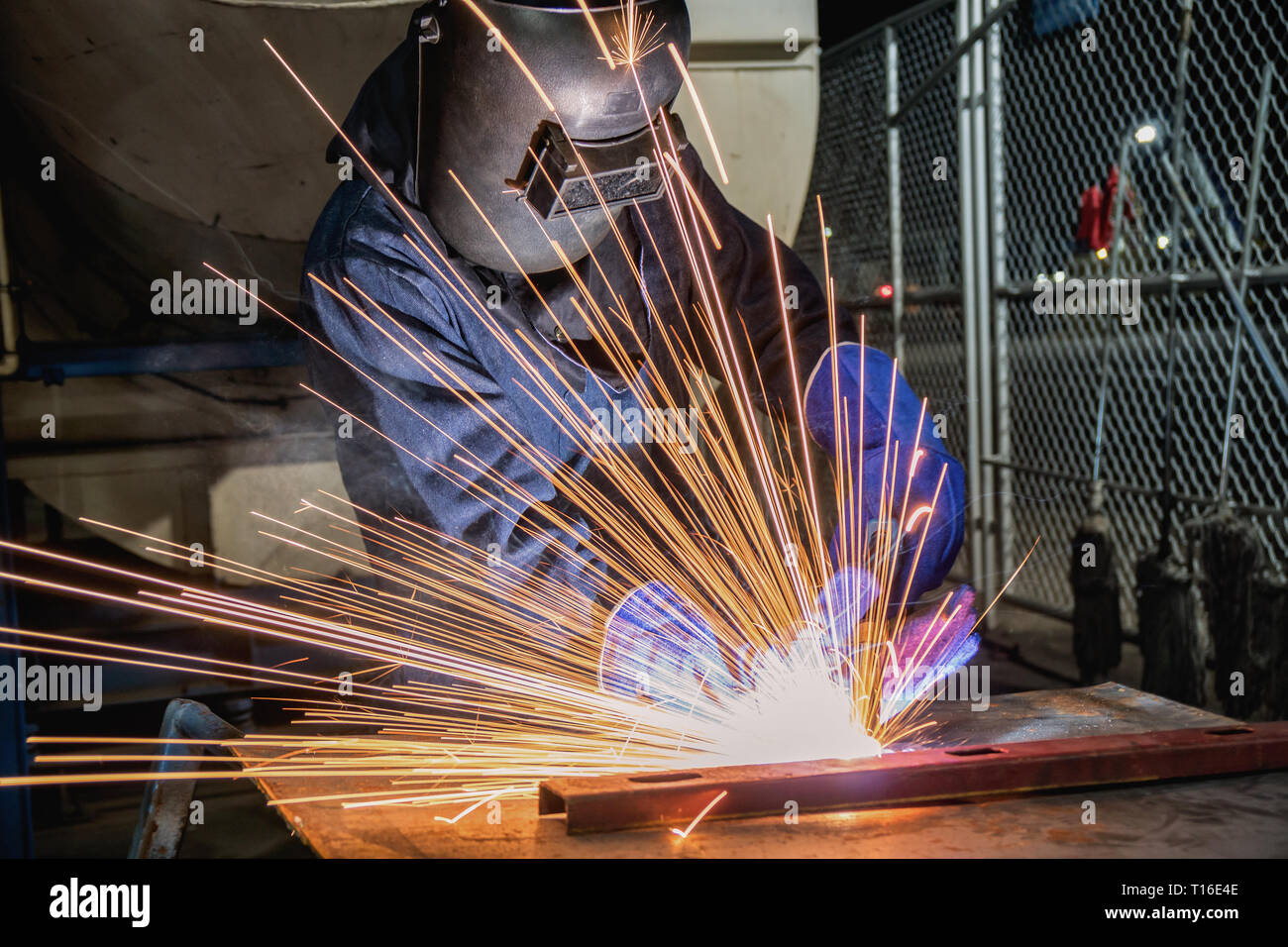Industrial worker is welding repair his work in factory Stock Photo